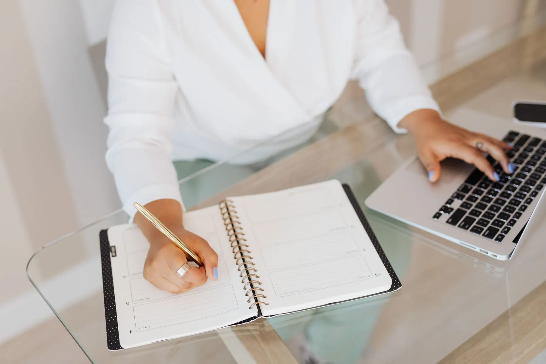 Professional creating a career plan with a laptop and notebook