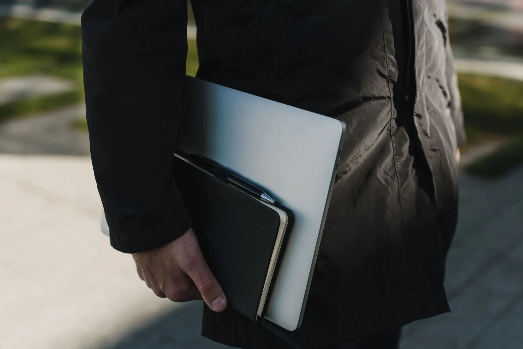 Professional carrying a laptop and planner for career development